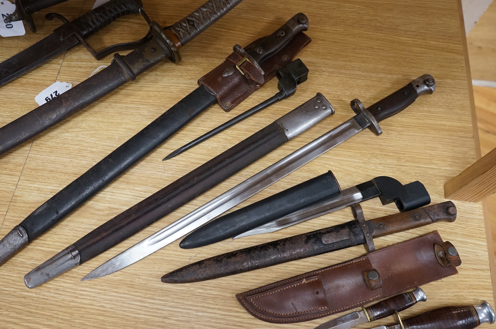 A 1907 bayonet by Wilkinson in its steel mounted leather scabbard, another similar with leather frog, two small British bayonets, a Continental bayonet, and two assorted hunting knives (7)